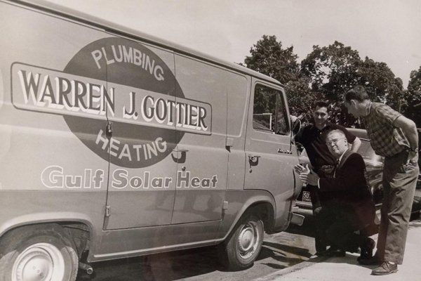 The original Warren J. Gottier Plumbing and Heating van with the founders, 1960s
